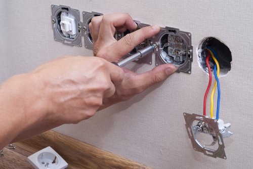 Commercial Electrician Installing an Electrical Socket Safely in San Jose